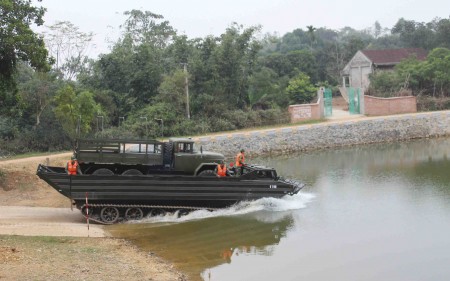 Xe xích lội nước TBS chở phương tiện thực hành vượt sông.