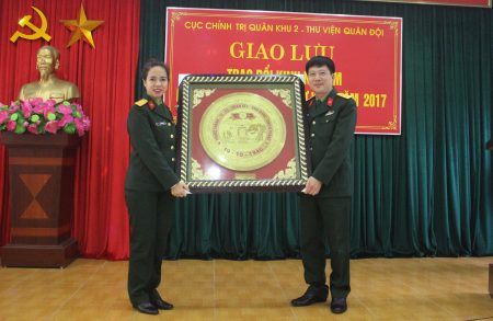 Thừa ủy quyền của Thủ trưởng Cục Chính trị Quân khu, Đại tá Nguyễn Như Bách tặng quà lưu niệm cho Thư viện Quân đội.